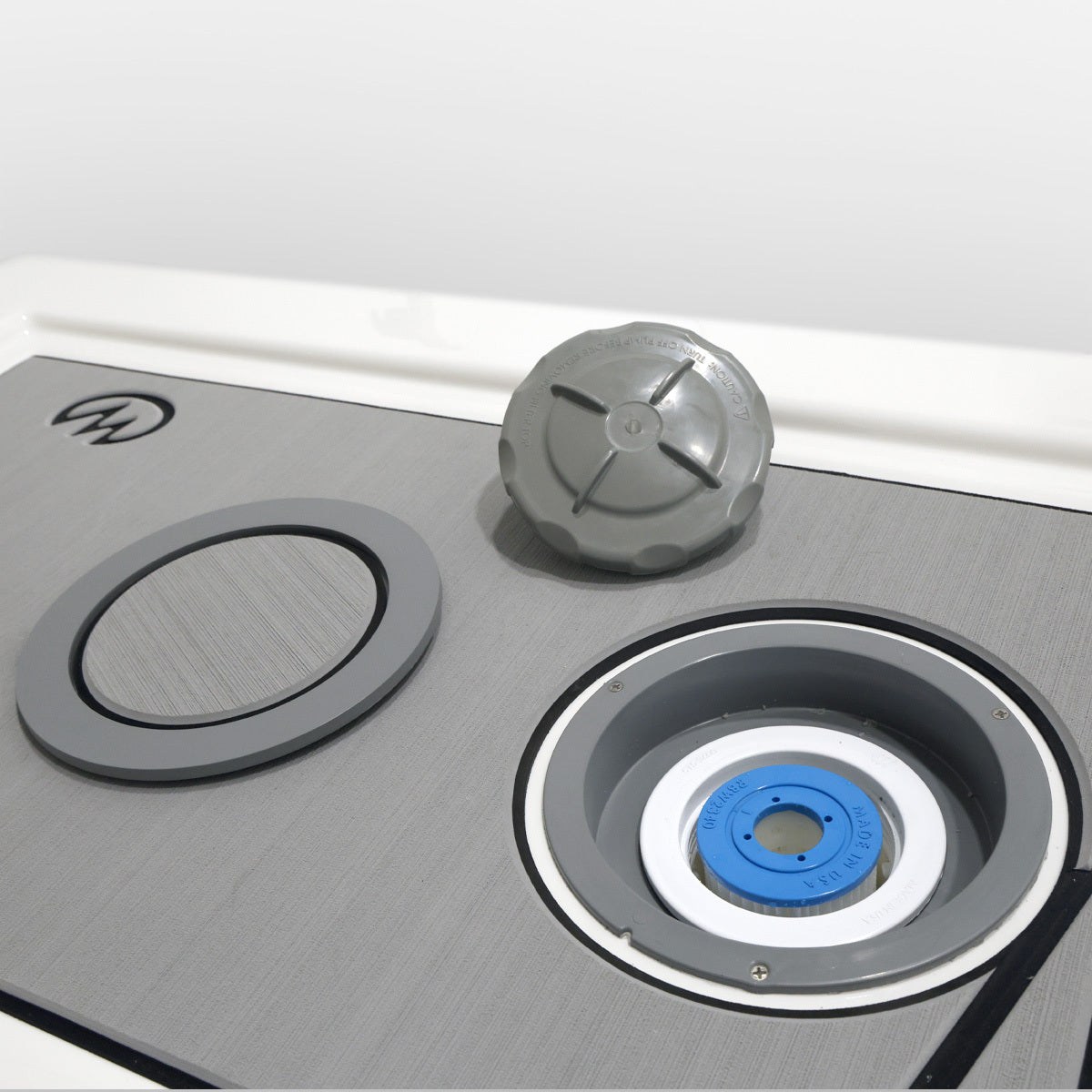 Close-up of a pressure feed filtration system with cover removed and filter visible.