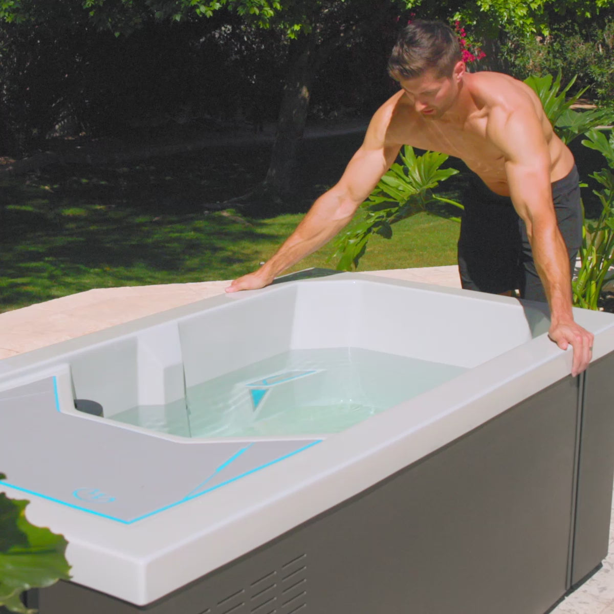 A man jumps into his cold tub in slow motion