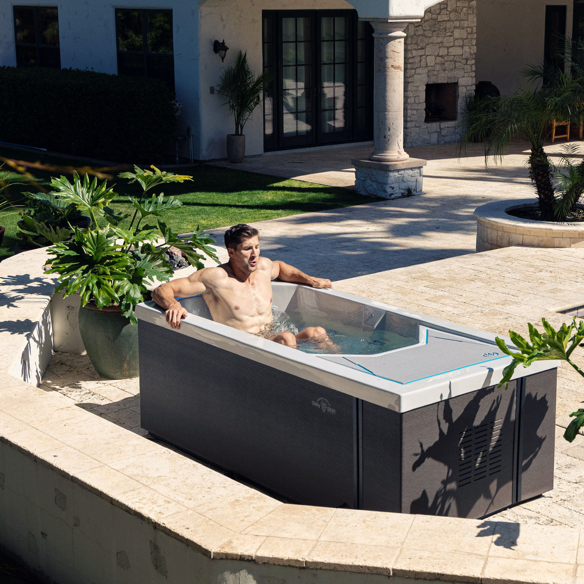 An man visibly exhaling as he settles into his cold tub