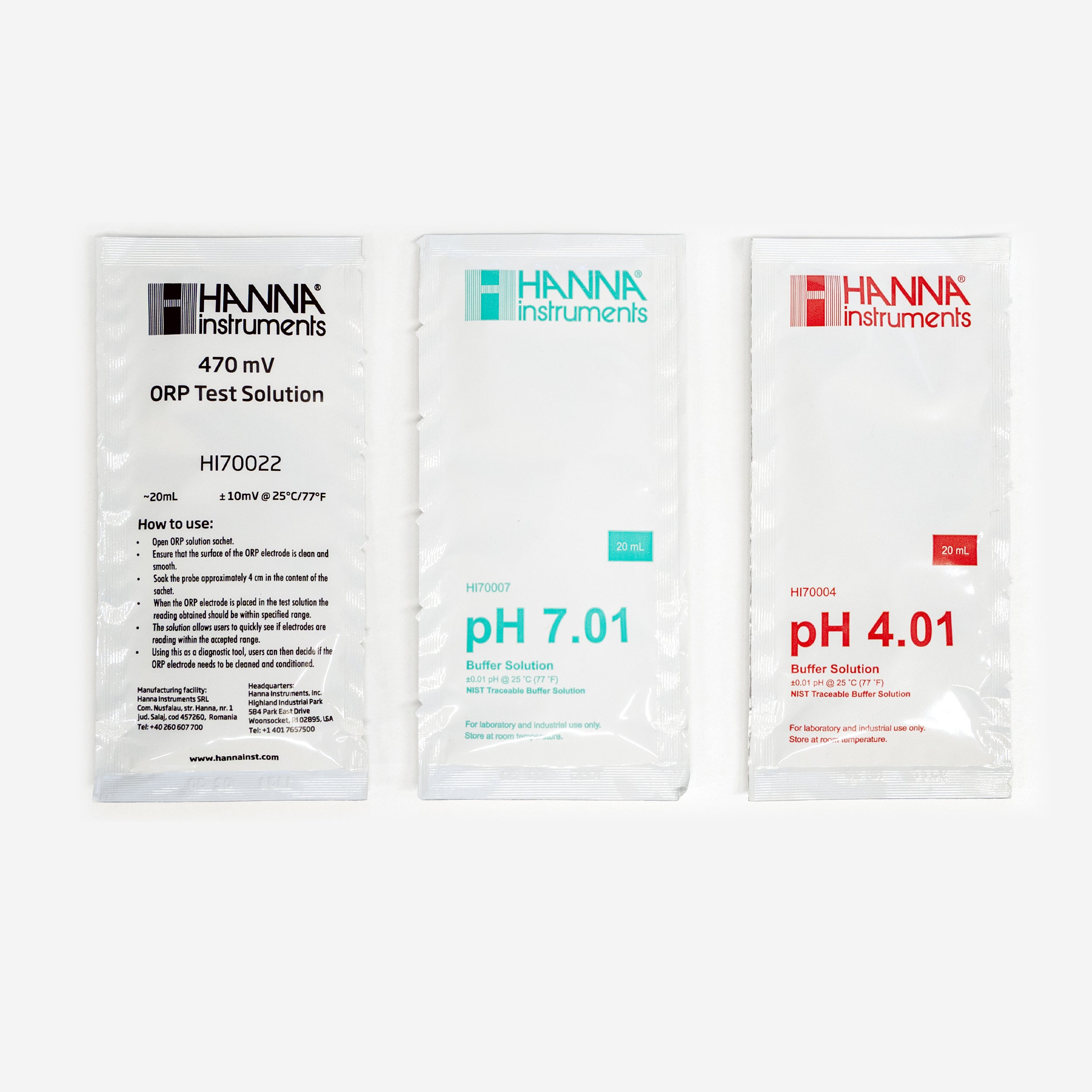 Three Hanna Instruments solution packets on a white background