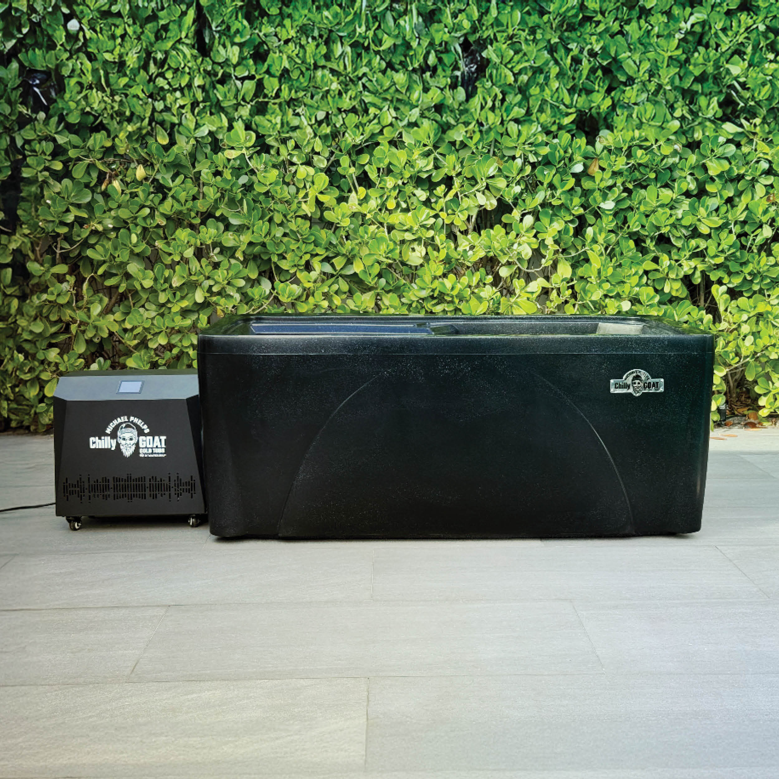 Wooden ice bath with a white interior and cover, placed on a tiled outdoor patio.