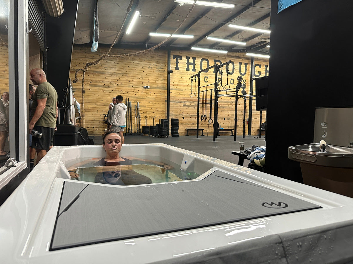 Person in a cold tub in a gym setting